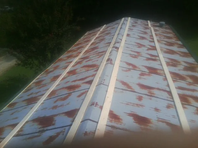 Rusted metal roof panels with new wood purlins before replacement — Storm Damage Roof Repair in Ebony by Roofing Brothers